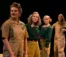 A picture of four student actors standing on a stage