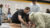 A professor/coach helps students tape ankles in the training room
