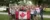 A picture of a group of Canadian students wearing red and white clothing while holding a Canadian flag