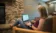 A picture of a women in the West hall lodge working on her laptop