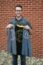 A picture of a man holding a week of welcome jacket