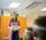 A teacher presents a tub full of shapes to a class