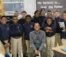 A group of kids pose for a picture with their teacher