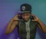A picture of a woman in a Twins baseball cap putting on headphones