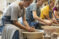 Female students working on pottery wheels