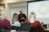 Male instructor leading a class looking at a projection