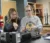 Chemistry instructor explains something to a student over a beaker in the lab