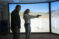 Student points gun at screen with faculty member advising