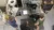 Two students and a faculty member work in a piece of equipment