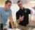 A male student and professor discuss a demonstration in the lab