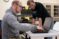 Two male students look at a laptop