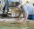 Student leans over to look at a tank with carp in it