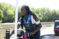 Female student drives boat on river for carp study project