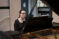 Female student plays the piano on stage