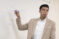 Male instructor pointing at whiteboard with marker