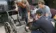A picture of three engineers working on a wheelchair