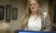 A picture of a women talking to someone out of focus