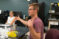 A student sits at a table and discusses a research project with others