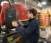 Male student works at a press machine in the manufacturing lab