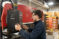 Male student works at a press machine in the manufacturing lab