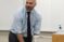 Professor Matthews stands at the front of class and smiles as he says something
