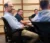 a group sits around the table in a city council meeting