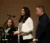 Two faculty members stand on stage leading an event addressing mental health in communities for social workers and law enforcement