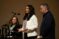 Two faculty members stand on stage leading an event addressing mental health in communities for social workers and law enforcement