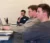 Male student sits in class thinking with his hand holding his chin
