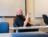 Professor uses his hand holding a pen to explain a concept to his class