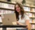 Female student sits in the library on her laptop