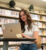 Female student sits in the library on her laptop