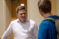 Male guest speaker listens to student after class