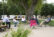 Group of faculty instructors sit in circle of lawn chairs on patio with sunglasses on