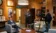 Two men film a politician in his office