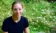 A picture of a woman sitting in the grass