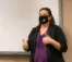 A professor teaches class with a mask on