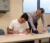 Actuarial science professor leans over to check in with a student and their work