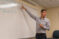 Actuarial science professor points to an equation on the whiteboard