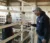 A female student speaks with the farm steward in a sheep pen