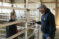 A female student speaks with the farm steward in a sheep pen