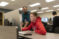 Male student working with faculty member at a computer