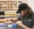Male student in baseball cap sorting samples in lab