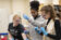 Three female students in lab looking at samples