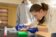 a female student sorts small plastic sample containers