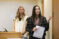 two female students present in front of the class