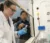 Faculty member points to test equipment used by a student in the lab