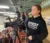 Female student works a camera for the Dordt Media Network at a hockey game