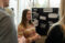 Female student speaks with other students about a presentation