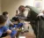 Sheriff working with student to fingerprint a bottle in the classroom